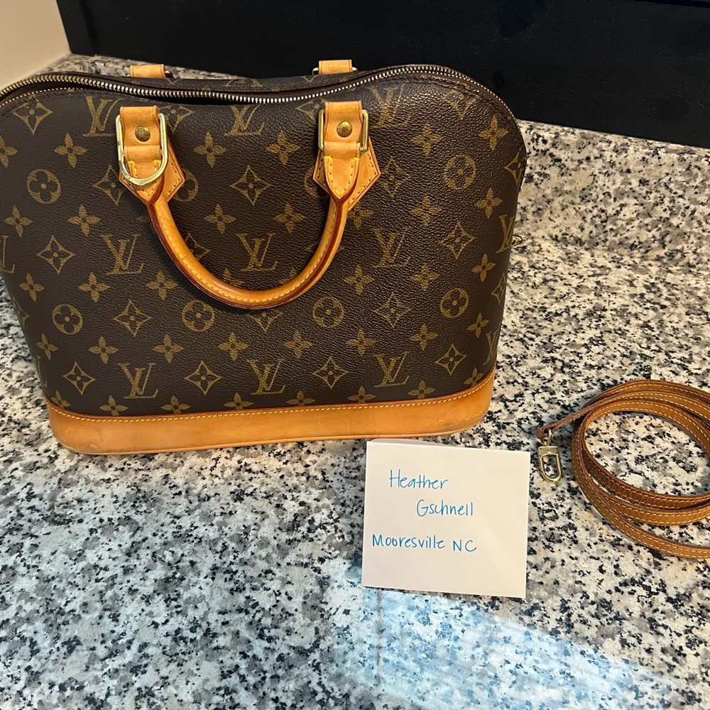 Louis Vuitton Alma Monogram Handbag with Tan Accents, cross body strap included.